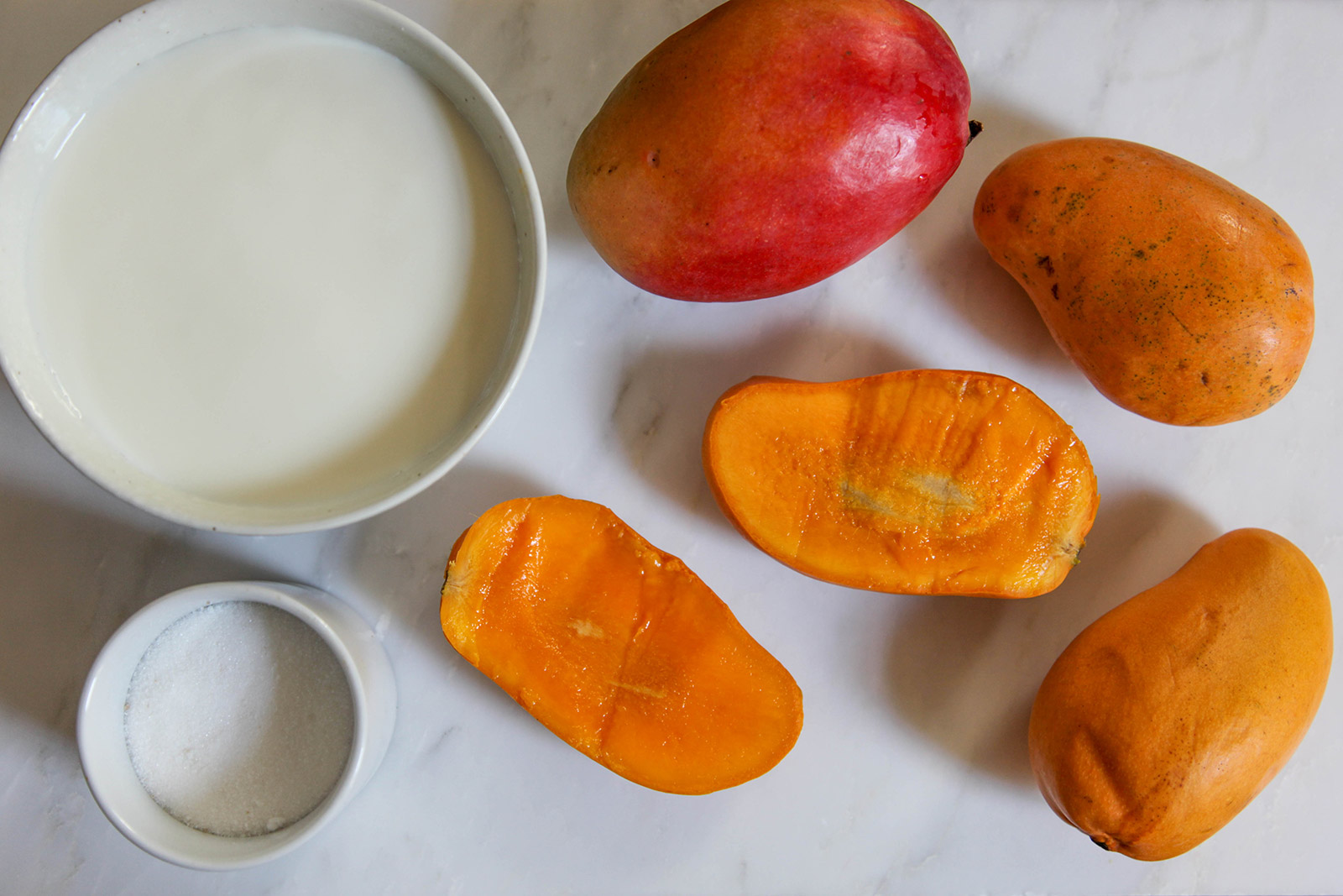 Ingredients for "aamer pona", simple heavenly dessert of sweet mango in creamy milk dessert of sweet mango in creamy milk