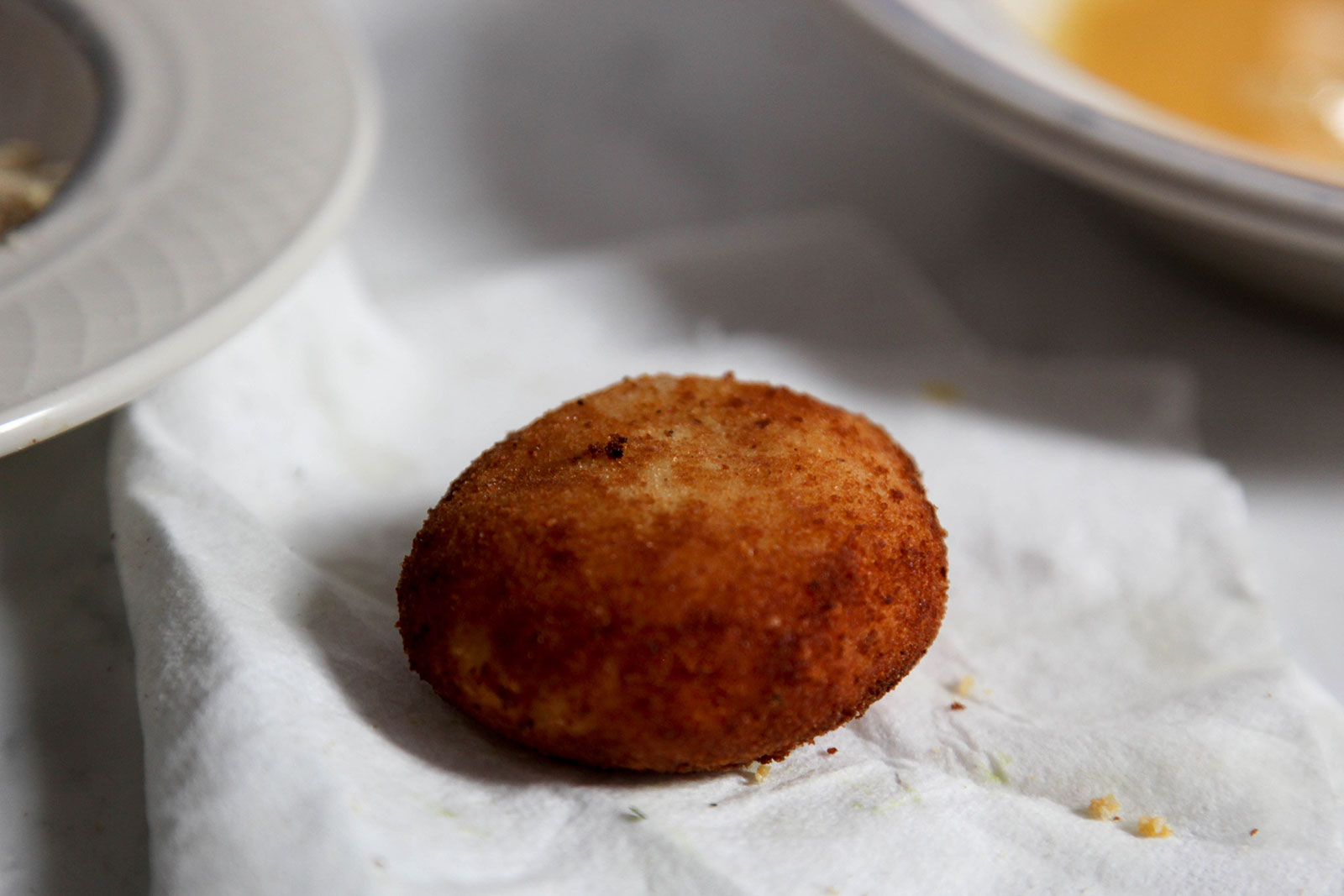 Fried croquette cooling on paper towel