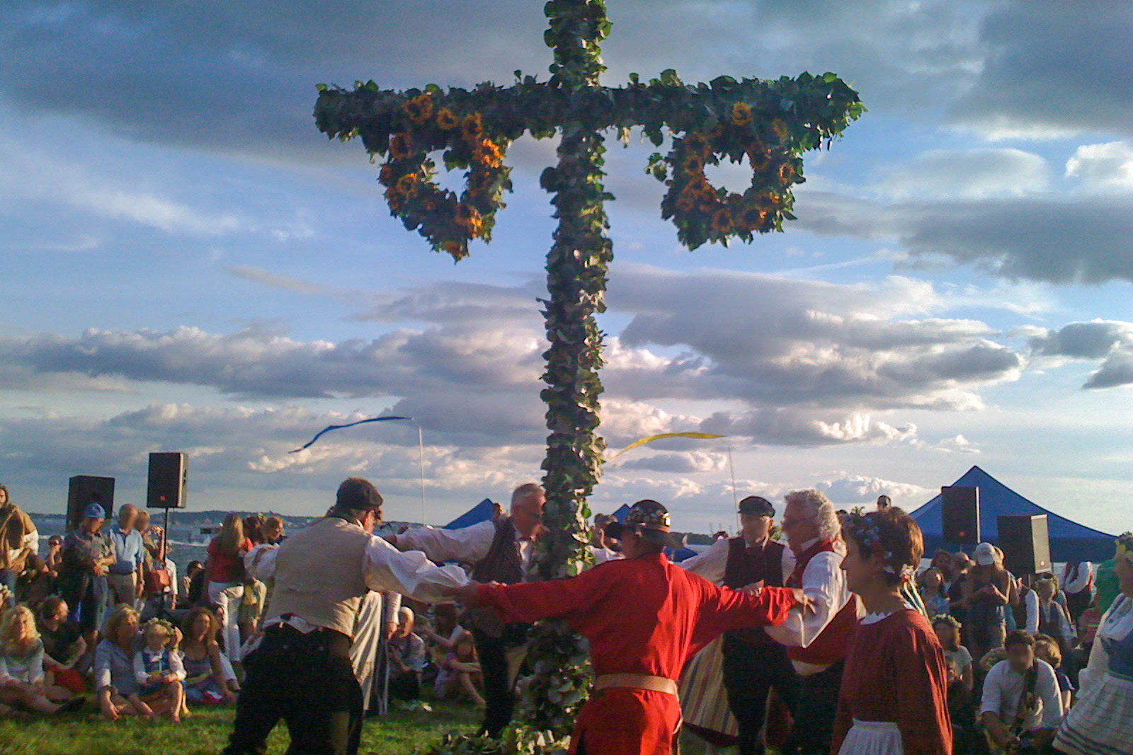 People dancing around a maypole at the Swedish Midsummer festival in NYC