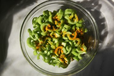 Chichinga slices in a bowl sprinkled with turmeric and salt