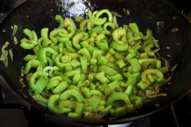 Sliced chichinga cooking in a wok