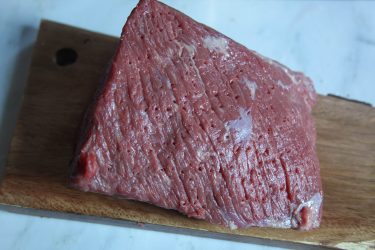 Beef pierced with fork prior to brining