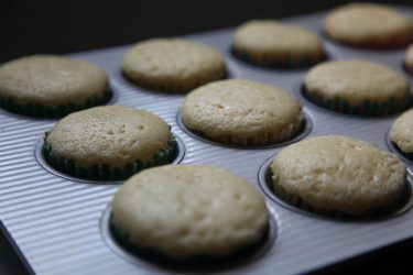 moist fluffy cupcakes just out of oven, resting in baking pan