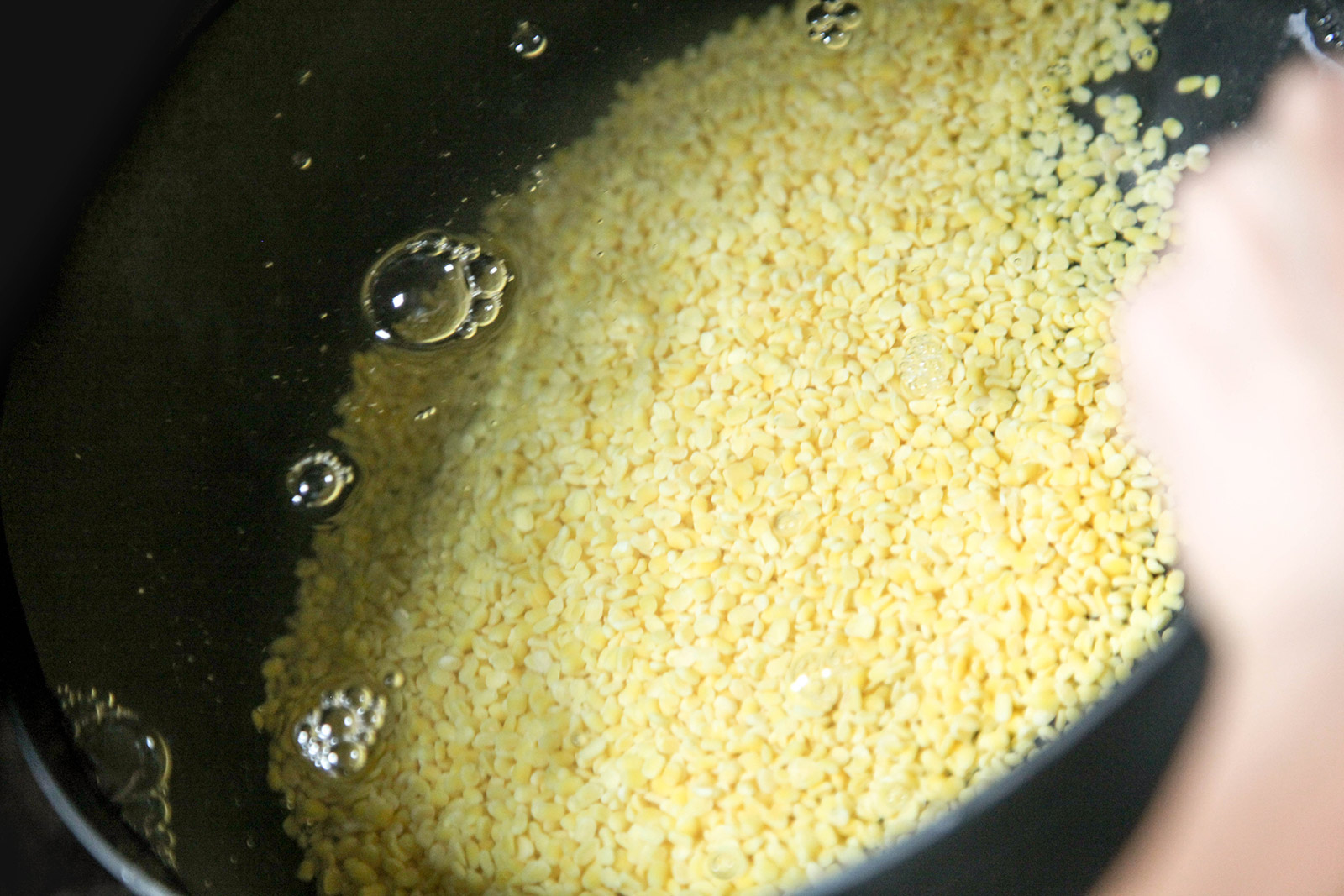 Rinsing lentils for Golden Yellow Dal (Lentil Soup) with Turmeric, Garlic, Cilantro