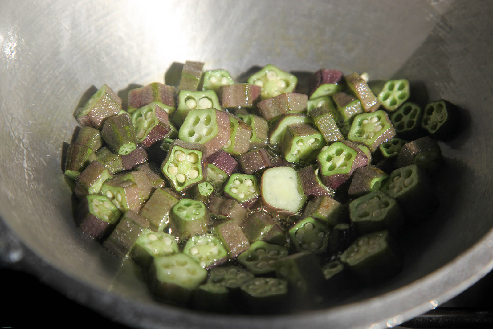 Okra slices frying in the wok