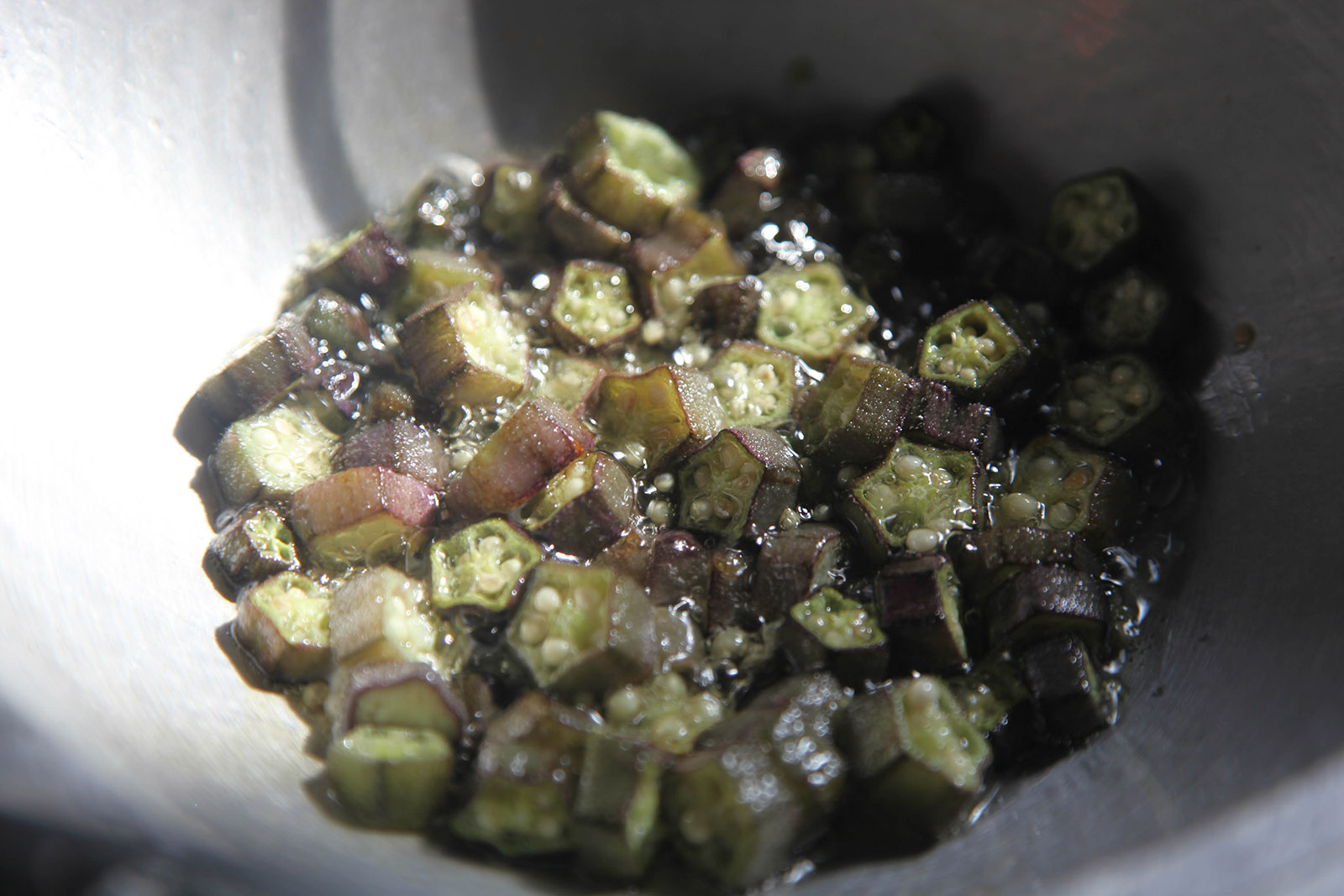 Okra slices after frying for a few minutes in the wok