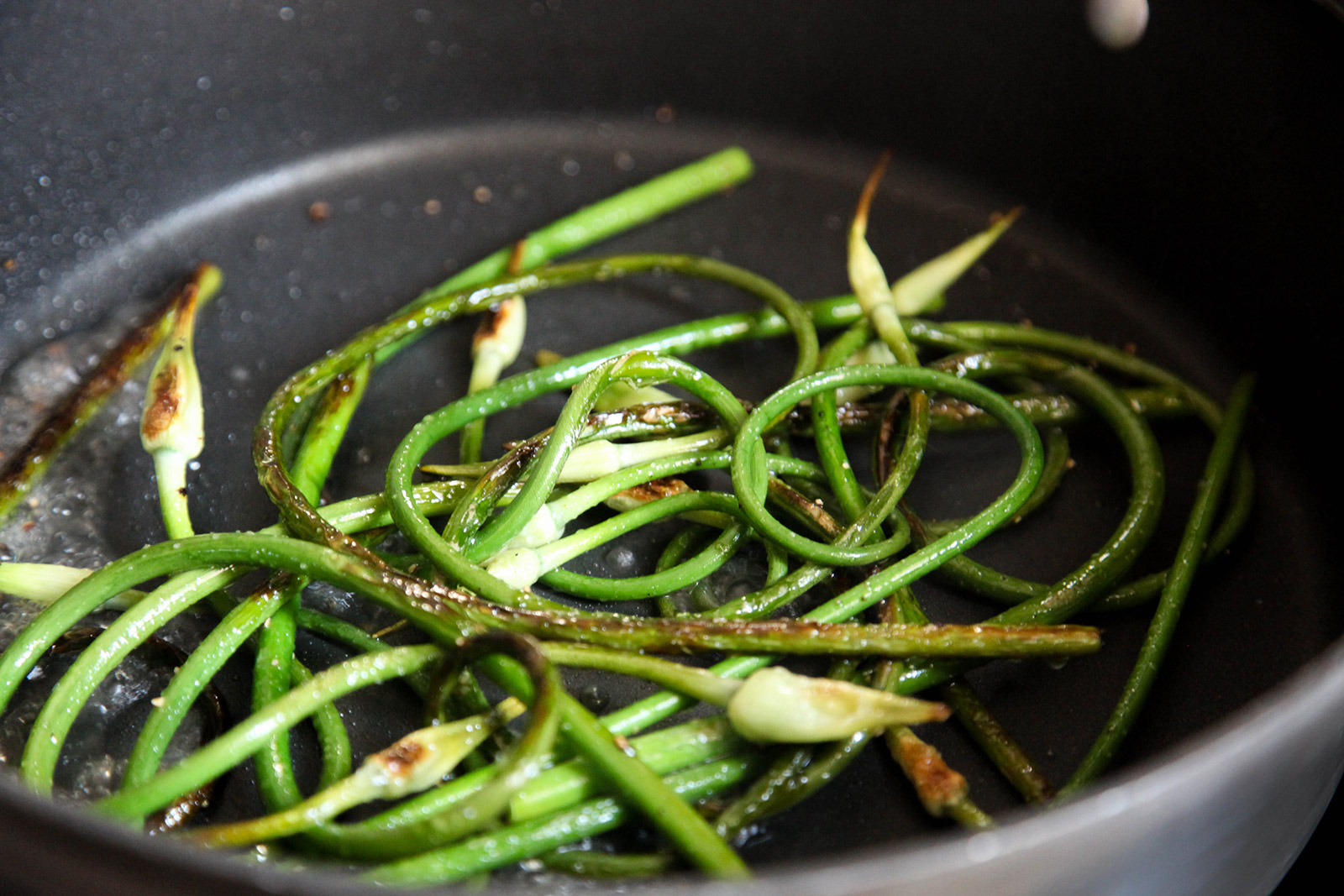 sauteeing garlic scapes with olive oil, salt & pepper