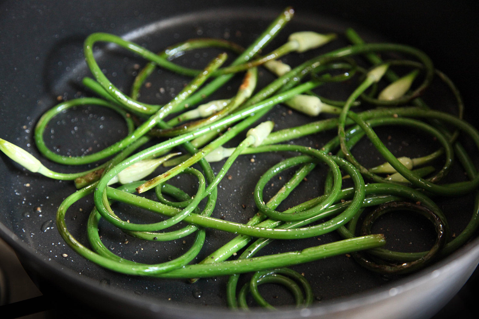 Sauteeing Garlic Scapes with Olive Oil, Sea Salt & Freshly Ground Pepper