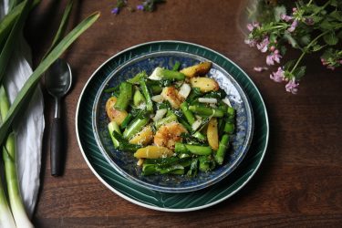 Green Garlic Sautéed with Shrimp, Potatoes & Grated Coconut, served on a plate