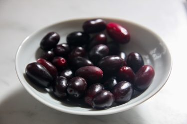 Jaam fruit (or black plums) in a bowl, ready to make Jaam Bhorta