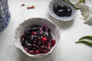 Jaam Bhorta or Black Plum Salsa in a bowl, and a small bowl or Jaam in the background