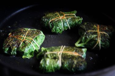 Paturi parcels cooking in a pan