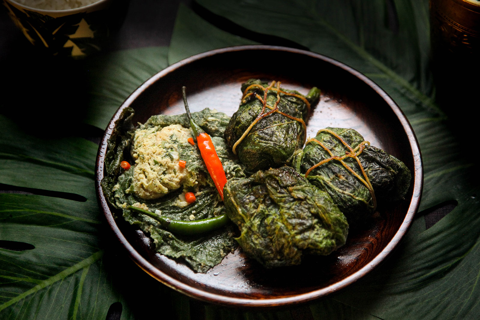 Paturi of Chicken Parcels wrapped in Squash Leaves shown on plate