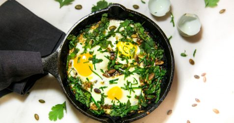 Crispy Potato Cake Nestled with Soft Baked Gooey Eggs, topped with Fresh Chives and Toasted Pumpkin Seeds