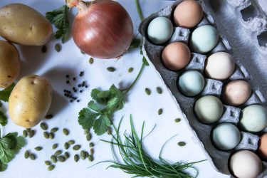 Ingredients for Crispy Potato Cake Nestled with Soft Baked Gooey Eggs, topped with Fresh Chives and Toasted Pumpkin Seeds