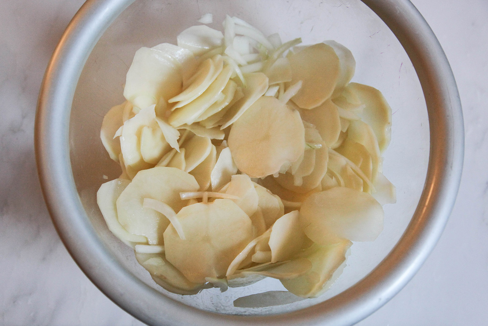 potato slices mixed with onions & olive oil