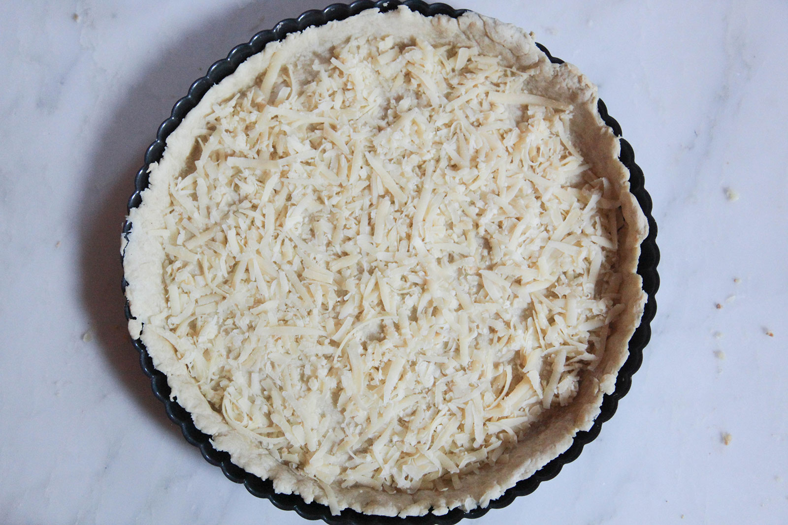 Pie Crust with layer of shredded cheese