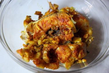 Fried fish set aside in a bowl