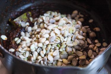 Sheem bichi added to pot with cooked spices