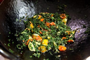 My sukuma wiki cooked in a wok, ready for serving